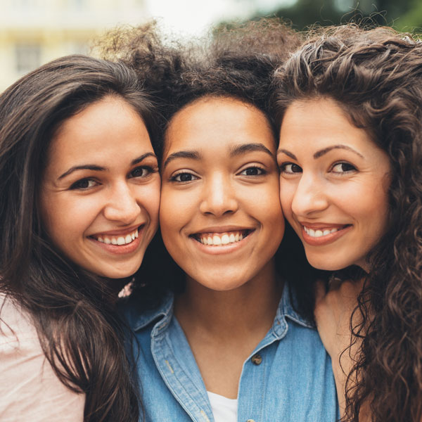 three friends smiling
