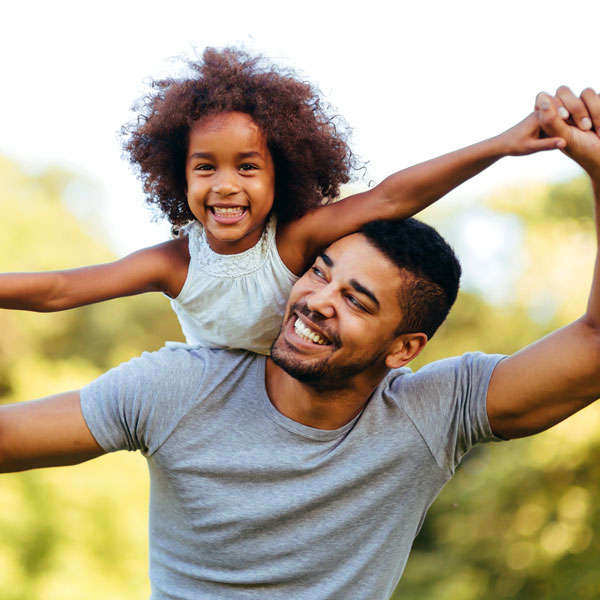 father and daughter playing outside