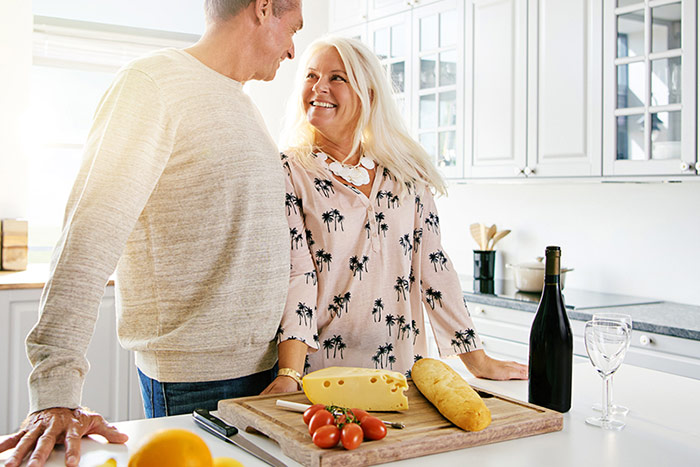 Senior couple eating cheese