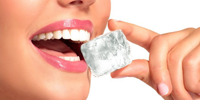 Woman biting an ice cube