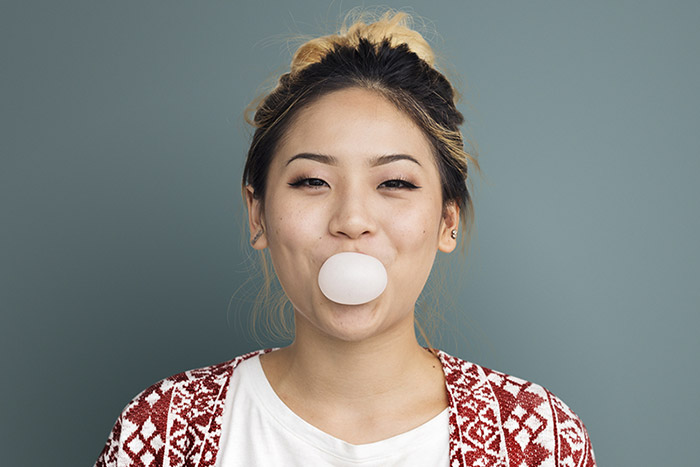 Woman blowing a bubble with gum