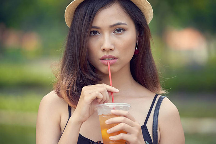 Woman drinking iced tea