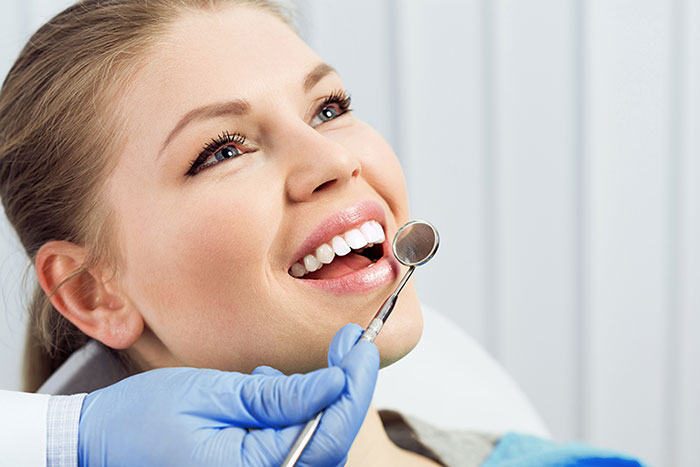 Woman getting her teeth examined