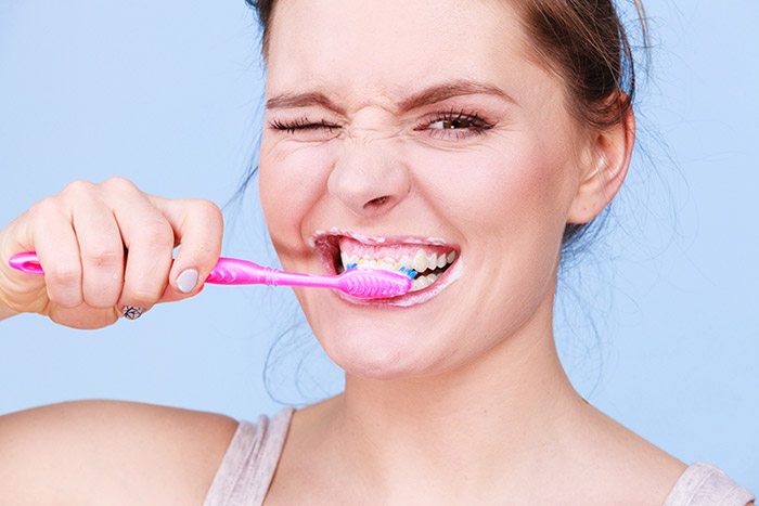 Woman brushing her teeth