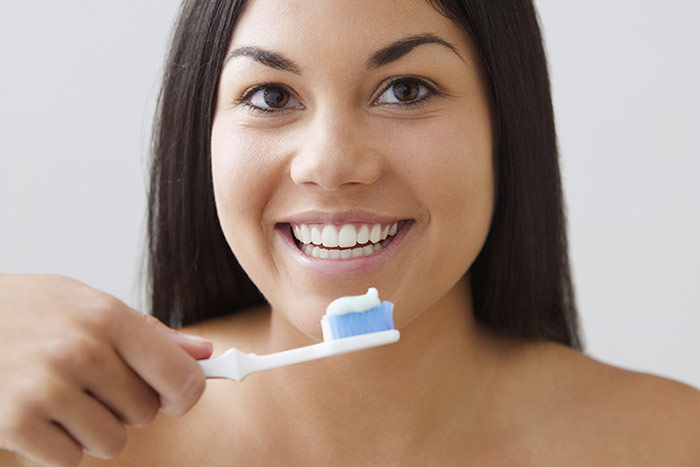 Woman brushing her teeth